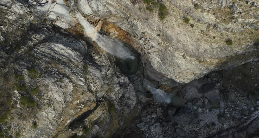 Waterfall amidst rocks in a natural environment