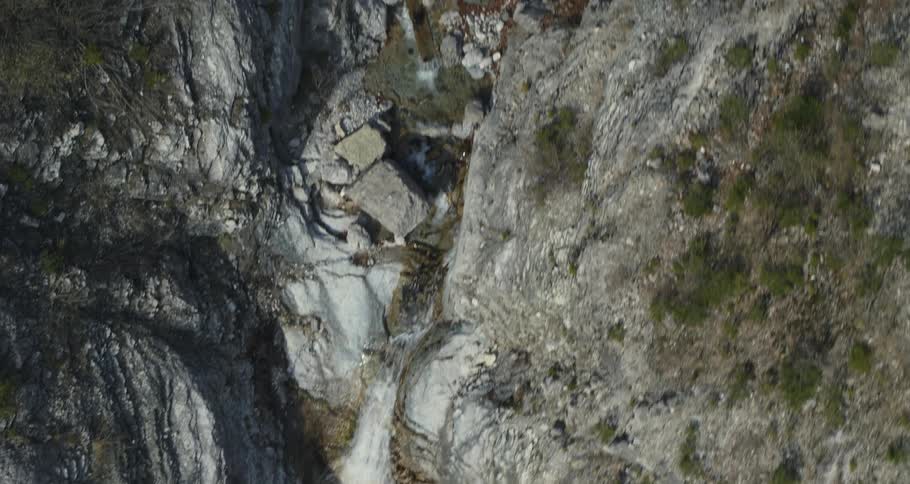 Small waterfall squeezing between rocks to make its way down the mountain