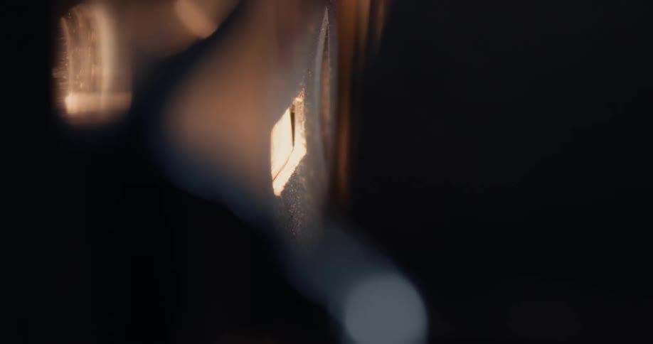 Amber lights flicker on and off behind a lens