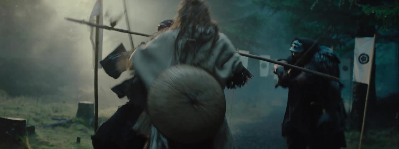 Lone warrior fights two opponents in foggy forest clearing