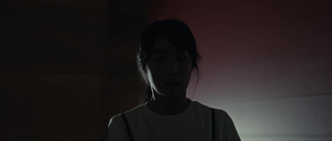 Obscured face of a young woman walking indoors