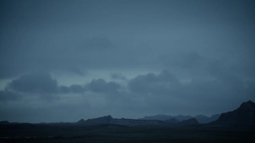 A flat region with gray storm clouds in the sky
