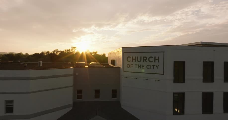Aerial view of a church center with the sunset on the horizon
