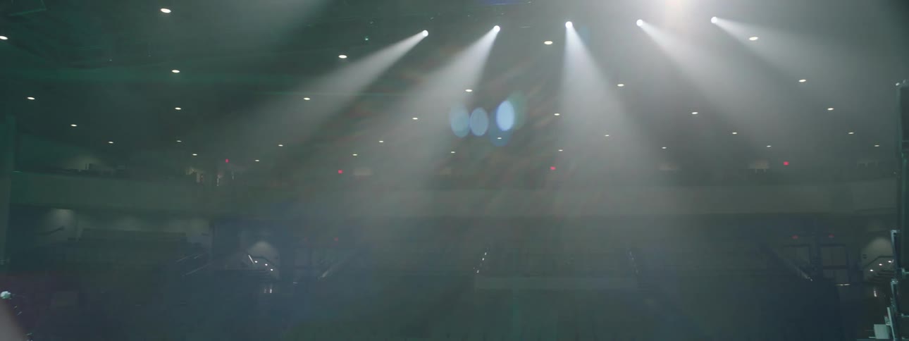 An empty concert stage with spotlights musical instruments and equipment set up