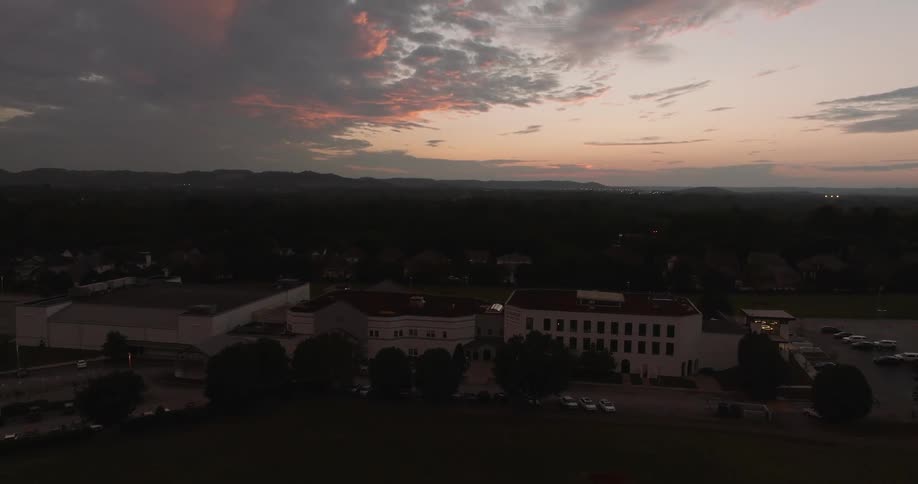 A large complex is under the cloudy sky