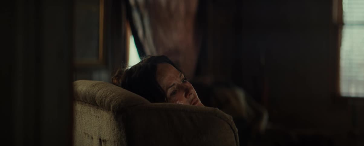 Woman lying in an armchair in the living room