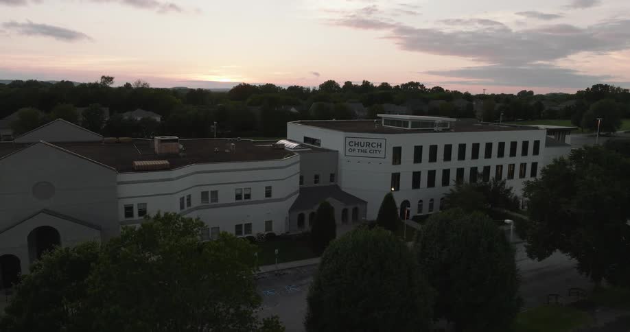 Buildings with a white facade during twilight with a partly cloudy sky