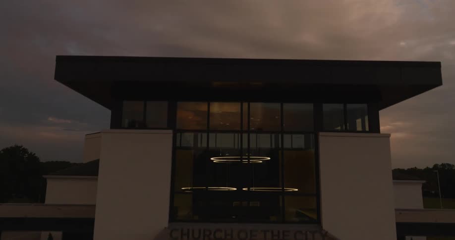 Facade of a modern building at dusk with a cloudy sky