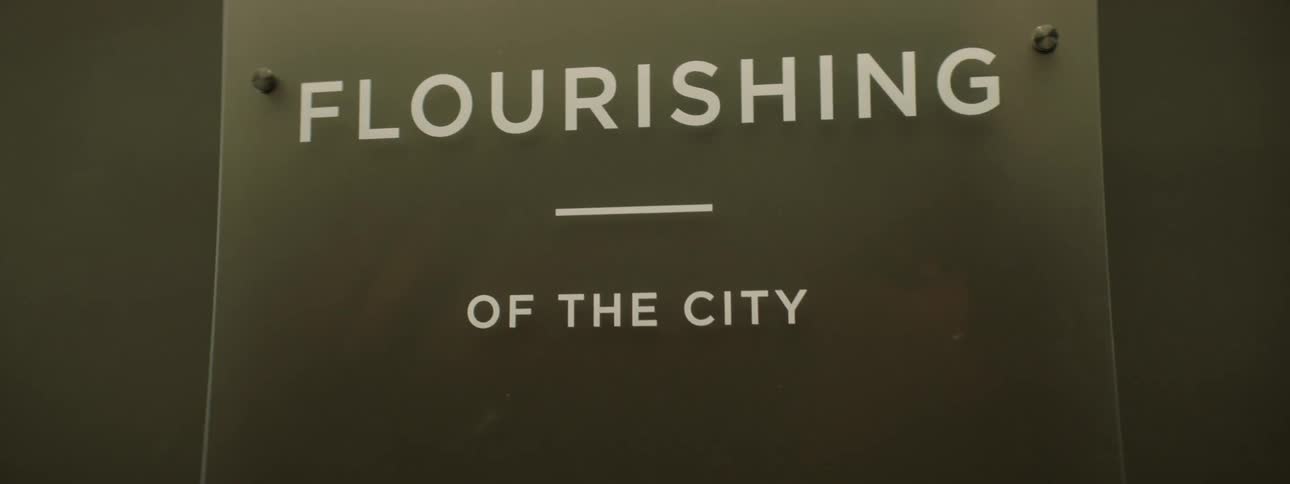 Glass plate with text written in white fixed on the wall
