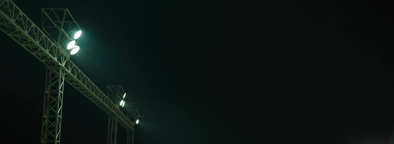 Some spotlights stuck in a tall metal frame and they are getting brighter and brighter