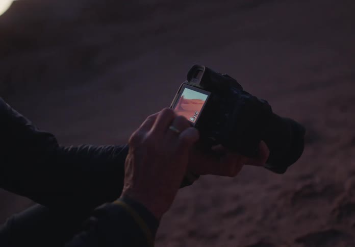 Pair of hands setting up a professional camera
