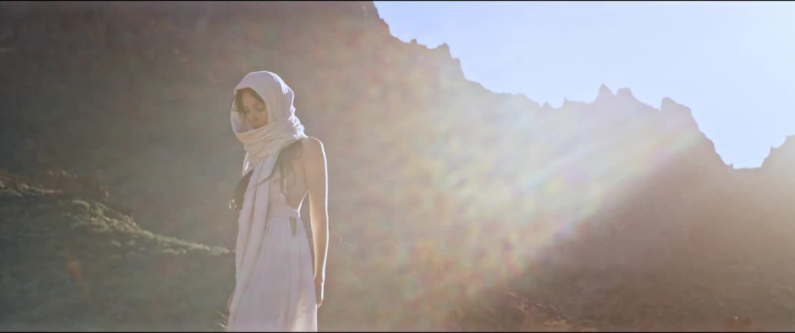 A woman walks past the mountain