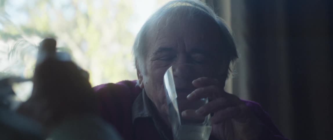 A man having a conversation at home toast with a glass of water