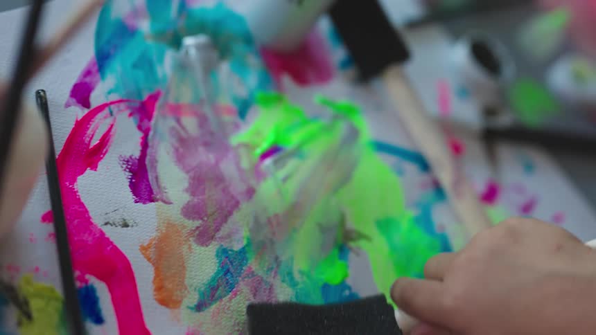 Girl hand painting a canvas with a brush