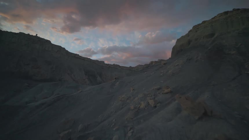 Rocky dunes and mountains at sunset