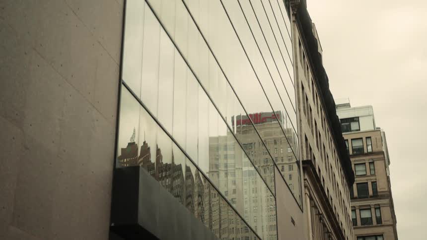 A city building reflects buildings located nearby