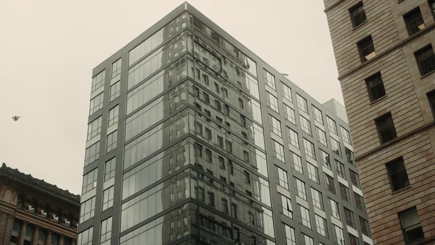 The exterior of multiple apartment buildings in a down to metropolitan area