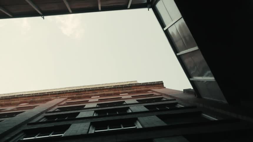 Clouds float over city buildings