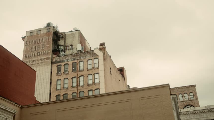 A cluster of old buildings against an overcast sky