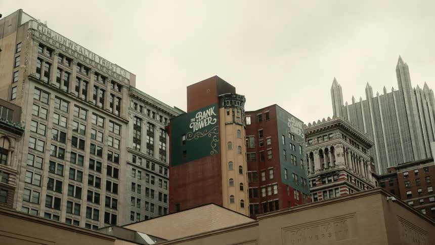 A series of tall city buildings bunched closely together