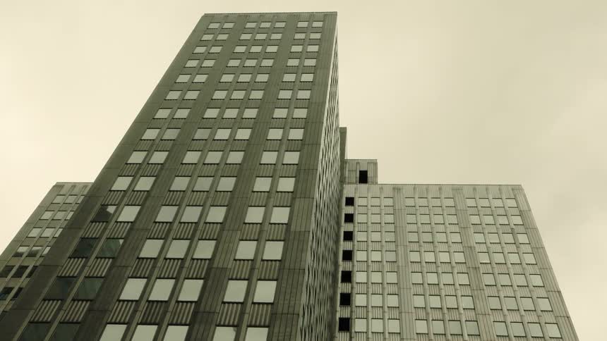 A tall building with two shorter structures attached