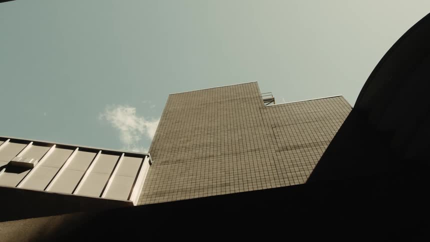A l shaped building attached to a smaller structure
