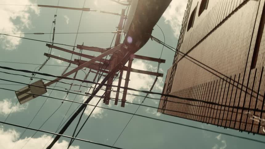 Upward view of a lamppost with surrounding buildings and wiring
