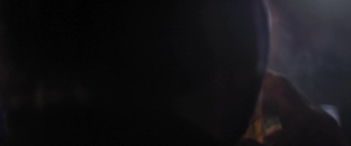 A man lights a cigarette and drinks