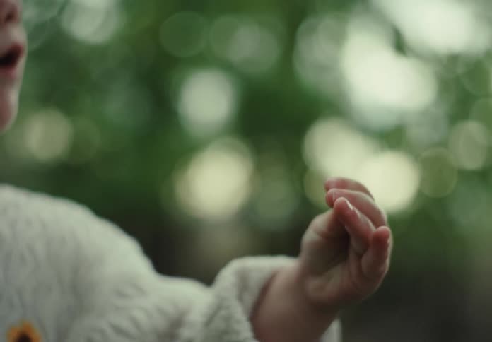 A child drops a flower
