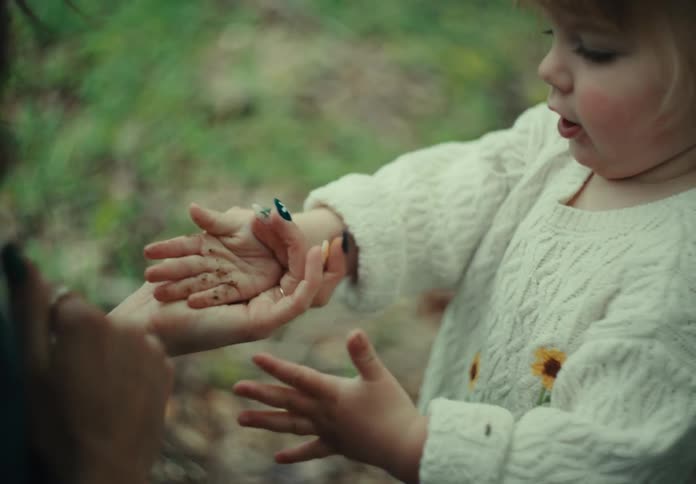 Mother cleaning her little daughters hand
