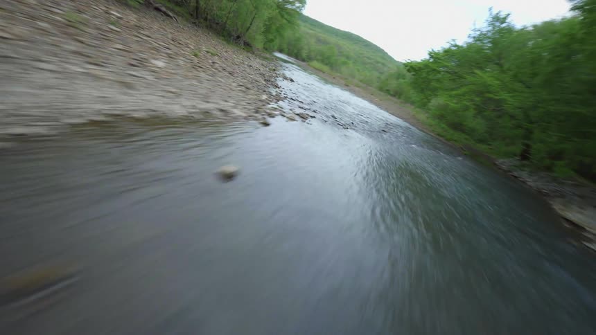 Aerial panorama of an extensive river that meanders through a forest