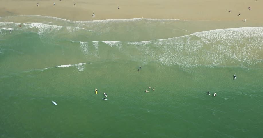 Aerial panorama of a turquoise beach with sunbathers