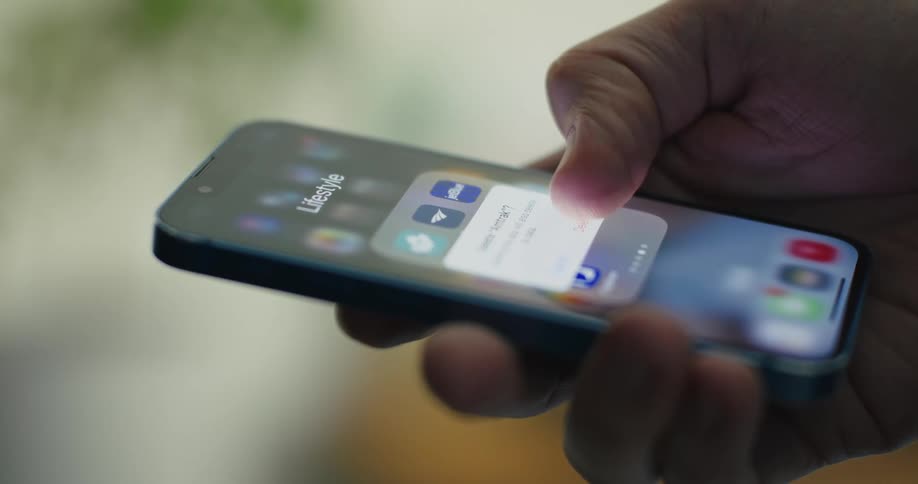 A white guy moves apps around on a smartphone