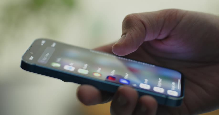 Closeup of a hand using an iphone