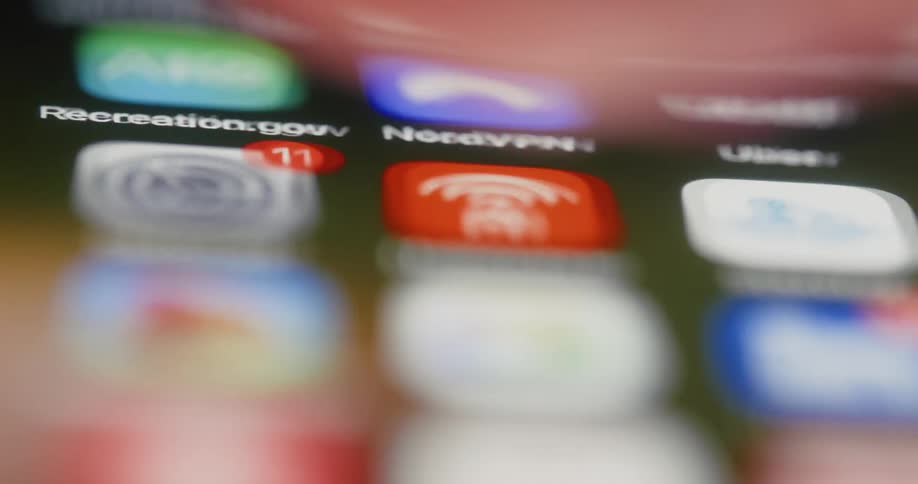 A person scrolls through apps on a smartphone