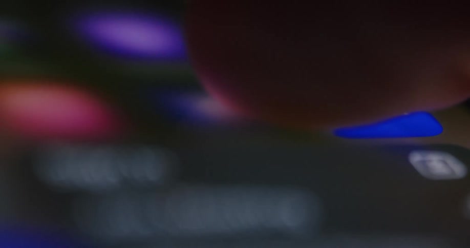 Extreme closeup of a finger pressing an iphone screen and moving apps