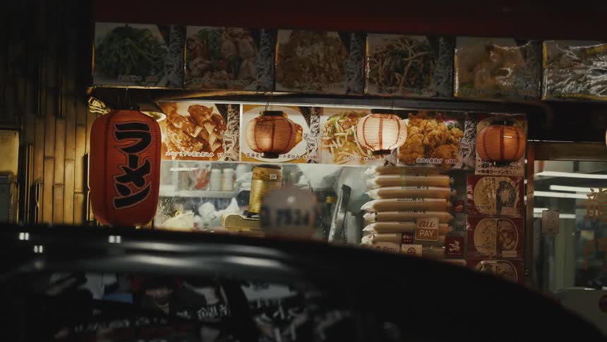 Illuminated window of an asian food store at night