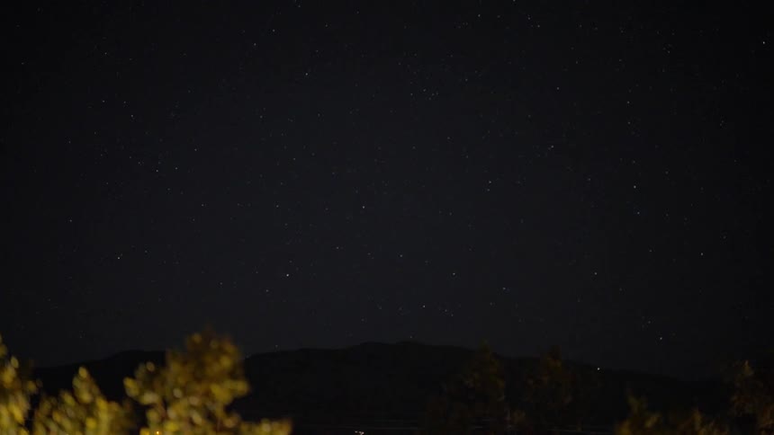 Planes fly over a mountain at night