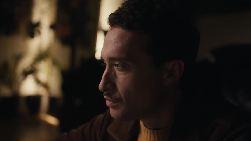 A man is sitting down looking at something