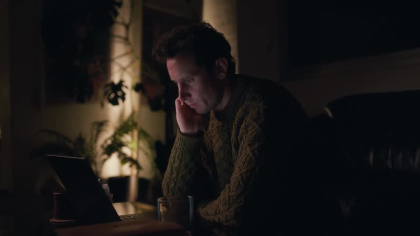 A man is typing on his laptop