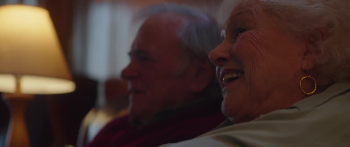 A couple are talking and smiling