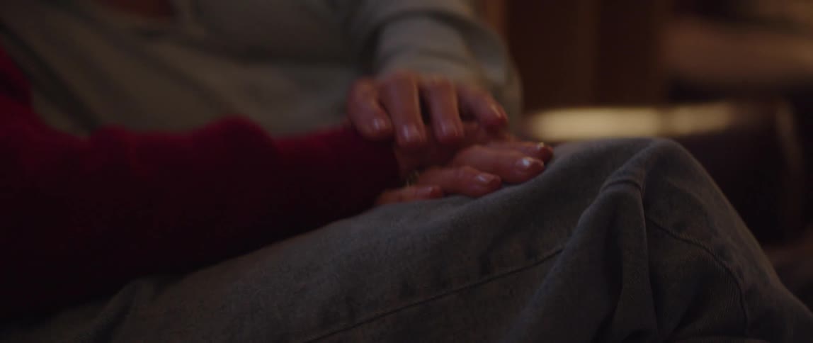Mans hand placed on top of a womans