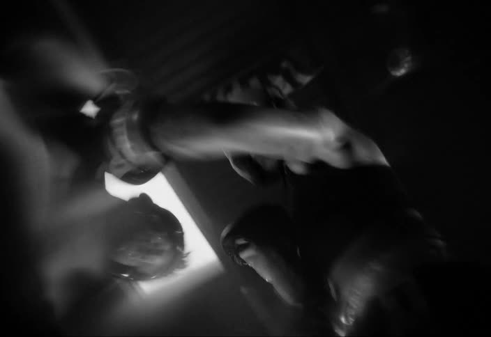 Two men boxing are throwing punches at each other and everything is in black and white tones