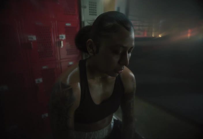 Boxer woman sitting down taking a deep breath
