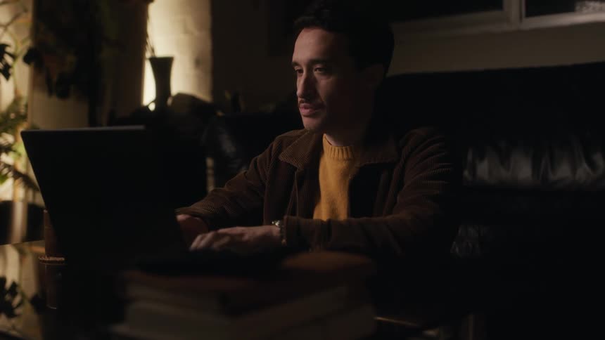 Man working on his laptop in a living room
