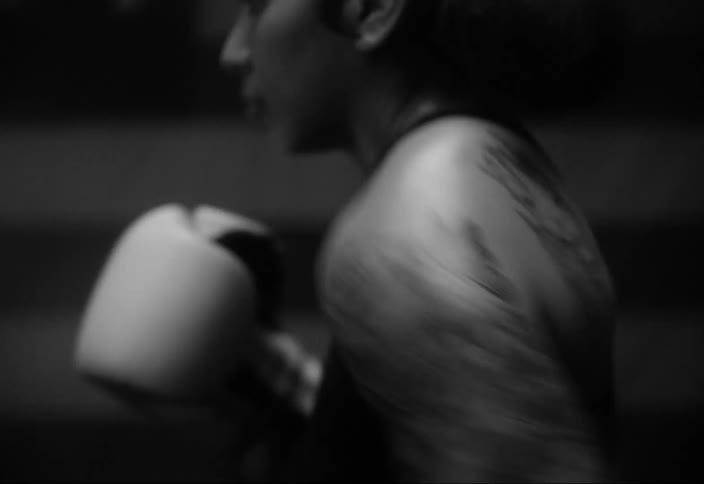 A woman is punching in front of the flag