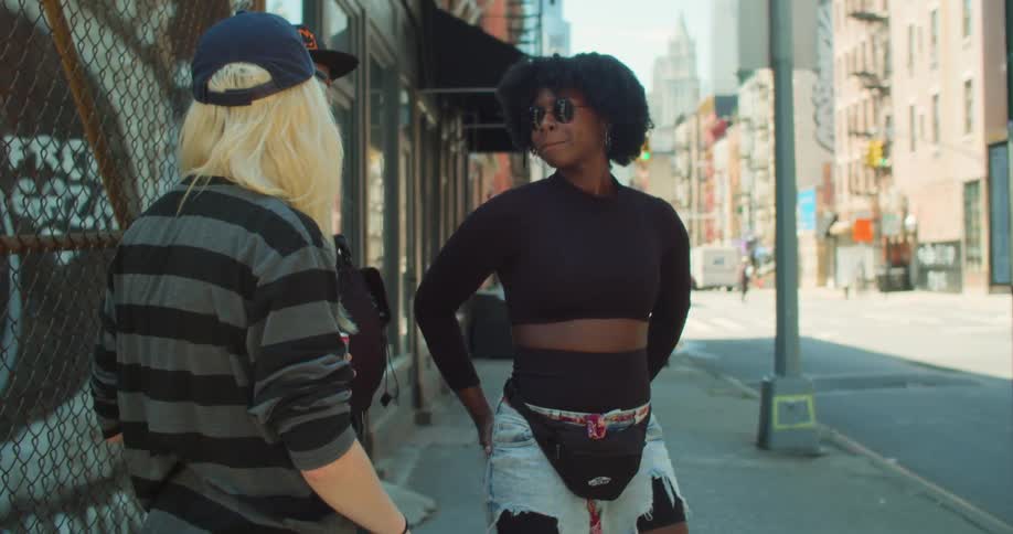 Three friends on the sidewalk talking