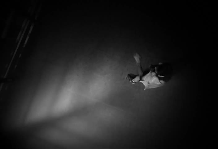Top view of a woman in a ring throwing boxing punches with lights flashing
