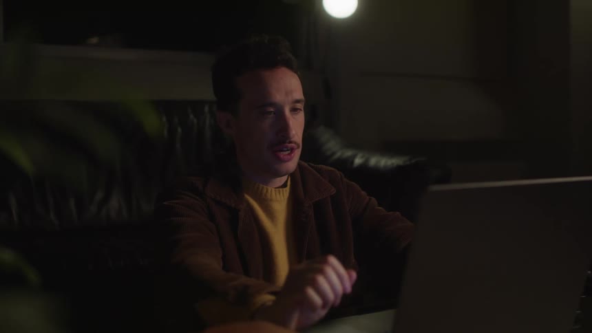 Man explains something over video chat before saying goodbye