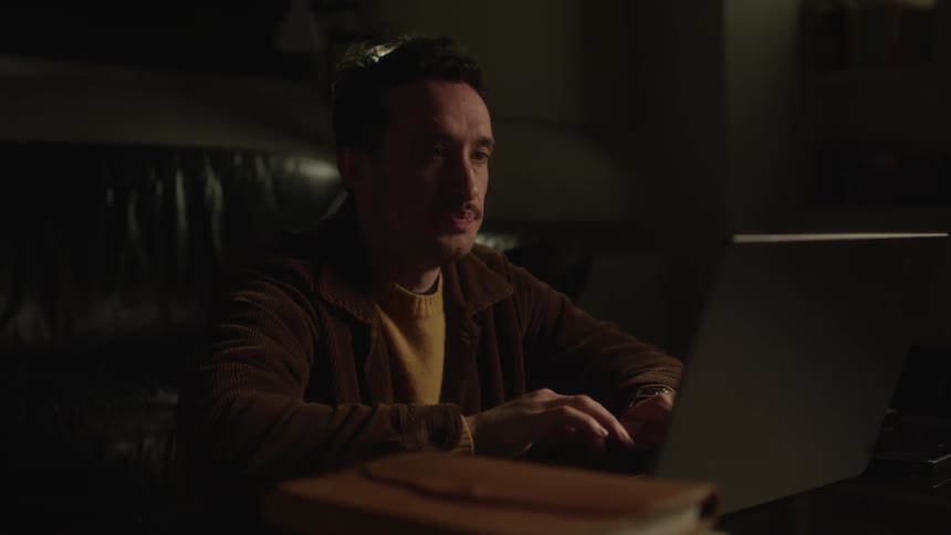 A man is using his laptop